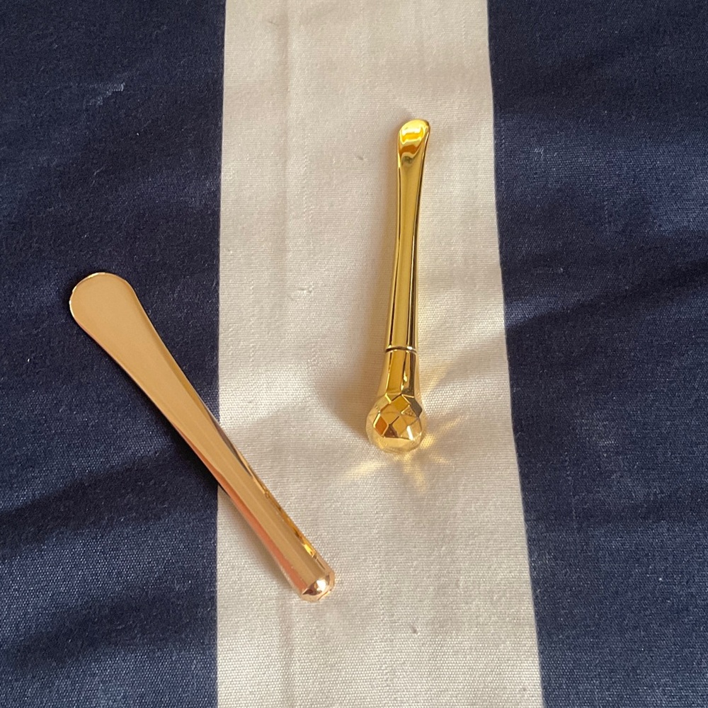 Elegant gold skincare roller ball and tool